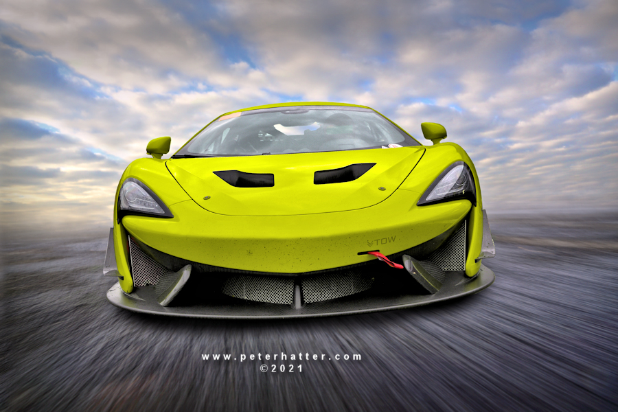 A speeding McLaren GT car.