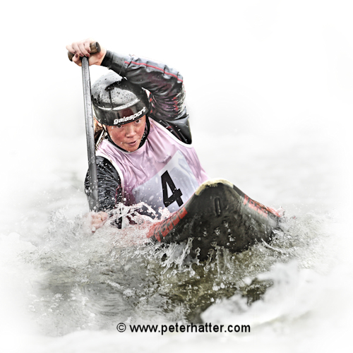 Sports photography example of white water canoe action on a white background.